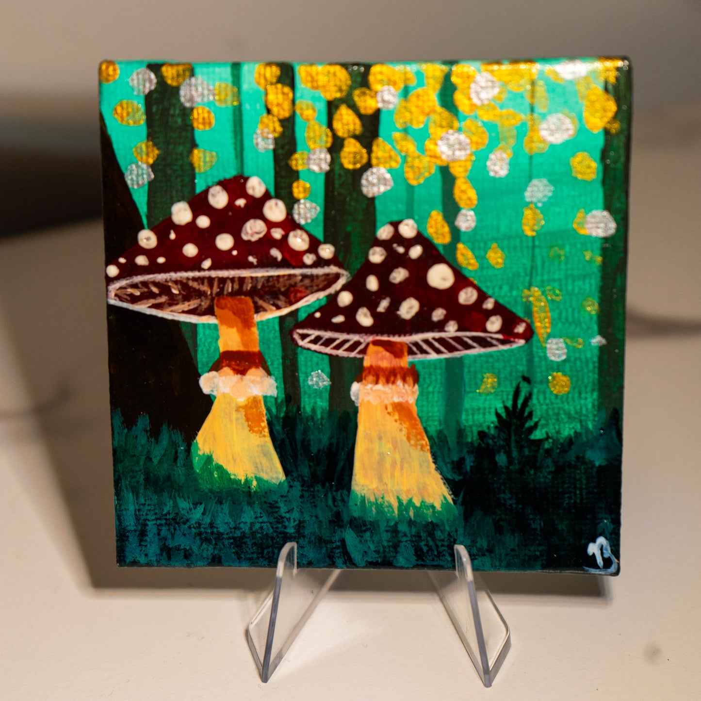 Painting of two mushrooms with polka dot caps on a stand
