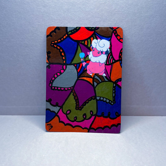 Flaffy Pokemon card with purple, grey, red, pink, green,brown, and orange design.
