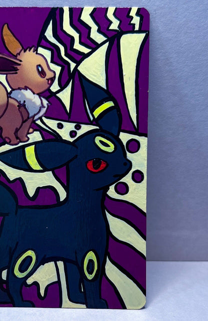 Eevee Original Pokemon Card Hand Painted with beige and purple with black line art featuring a proud standing Umbreon. Acrylic Paint with high gloss varnish finish sleeved and hard sleeved
